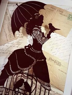 a paper cut out of a woman with an umbrella and birdcage on it