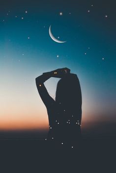the silhouette of a woman with her hands on her head looking up at the stars in the sky