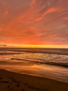 an orange and pink sunset over the ocean