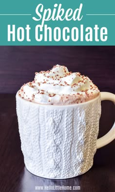 a white mug filled with hot chocolate and whipped cream