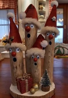 some wooden logs with santa hats on them