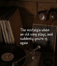 an old record player with headphones on top of it next to some vinyl records