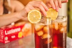 two glasses filled with iced tea and lemon slices