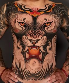 a man with tattoos on his stomach and chest