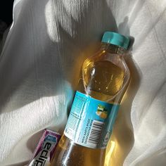 a bottle of water sitting on top of a bed