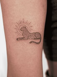 a small tattoo of a cheetah on the arm