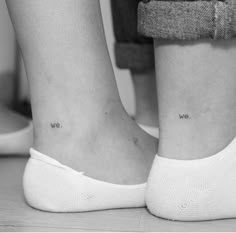 two people with small tattoos on their legs, one has the words we are in cursive writing