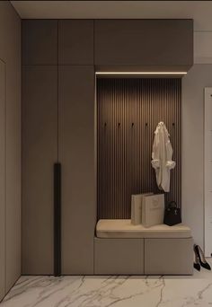 a white coat and some shoes in a room with marble flooring on the walls