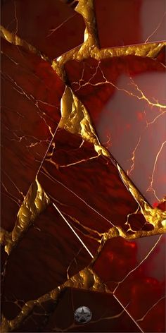 an abstract red and gold marble pattern with golden accents on it's sides, as well as the top part of its frame