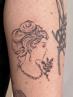 a woman's arm with tattoos on it