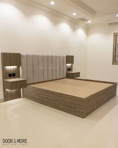 a large bed sitting inside of a bedroom next to a wall mounted shelf with lights on it