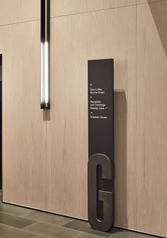 the entrance to an office building with a large g sign on it's side