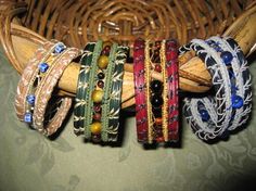 several bracelets are sitting on top of a wicker basket