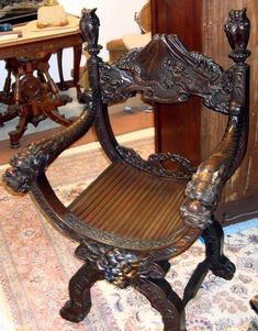 an ornate wooden chair sitting on top of a rug