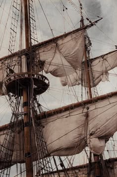 an old sailing ship with masts and sails