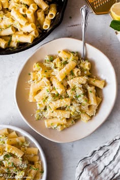 two bowls filled with pasta on top of a table