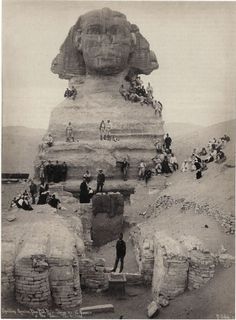 an old black and white photo of people standing in front of the great sphinx