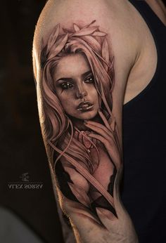 a woman with long hair and flowers on her arm is shown in this tattoo design