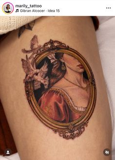 a woman's thigh with a mirror and birds on it