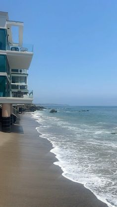 an ocean view with waves crashing on the beach