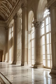 an empty room with marble floors and columns