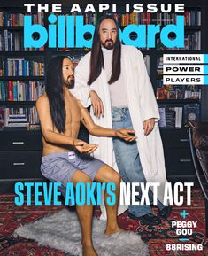 a magazine cover with two men in front of bookshelves and one man sitting on the floor