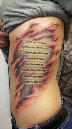 a woman's thigh with a fire tattoo on her stomach and words written in flames