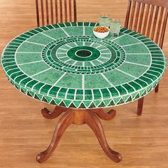 a green table with two chairs around it
