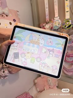 a person holding an electronic device in front of a wall with stuffed animals on it