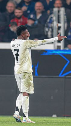 a soccer player with his arms out in the air