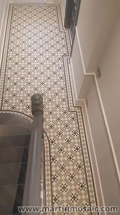 a hallway with tiled flooring and stairs