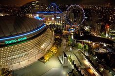 the tokyo dome is lit up at night