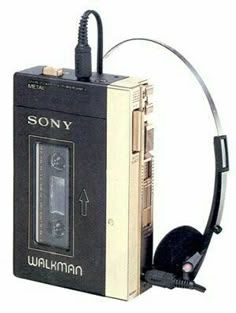an old fashioned walkman with headphones attached to it's back and side