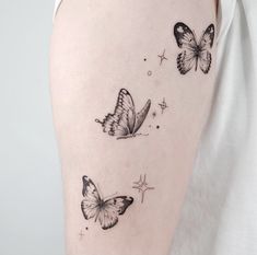 a woman's arm with three butterflies on it