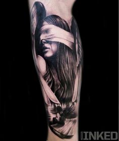 a woman with an angel tattoo on her arm