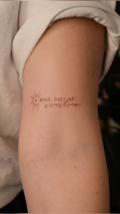 a woman with a tattoo on her arm that says soulful