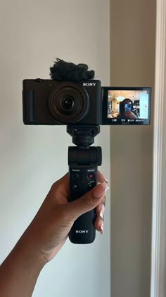 a person holding up a camera to take a photo with it's cell phone