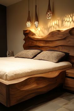 a bed with wooden headboard and pillows in a room that has lights on the wall above it