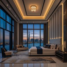 a bedroom with a large window overlooking the city at night and lit up by lights