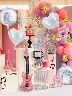 a room filled with balloons and musical instruments