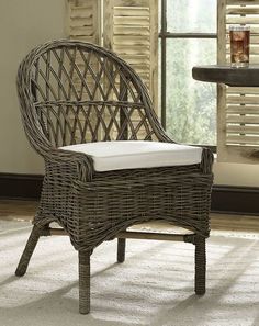 a wicker chair sitting in front of a window