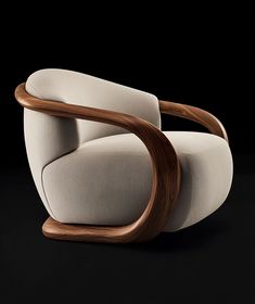 a white chair sitting on top of a black floor next to a wooden armrest