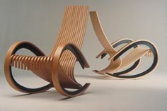 a wooden chair that is sitting in the middle of some sort of sculpture on a white surface