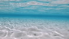 an underwater view of sand and water