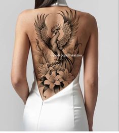 the back of a woman's body with flowers and birds on it
