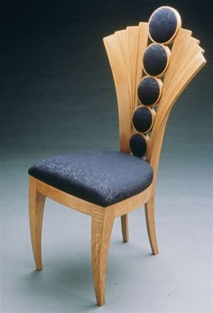 a chair made out of wood with black cushions on it's back and sides