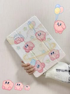 a person holding an ipad case with cartoon characters on it