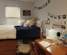 a bed room with a neatly made bed and desk