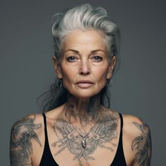 an older woman with grey hair and tattoos on her chest is looking at the camera