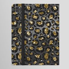 the black and gold leopard print is on top of an ipad case, while it's open
